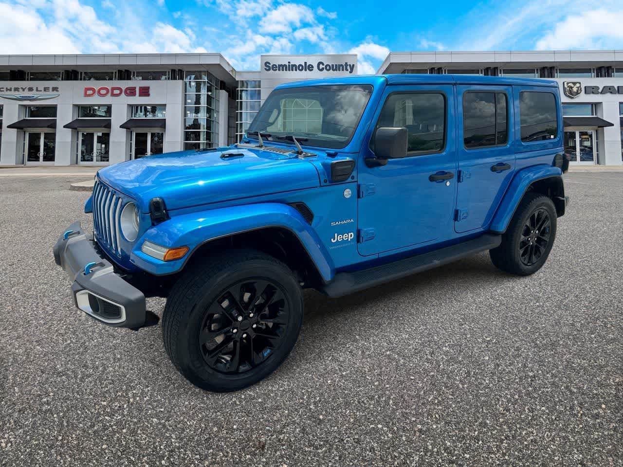 2023 Jeep Wrangler 4xe Sahara 4x4 in Hydro Blue Pearlcoat — front three-quarter view