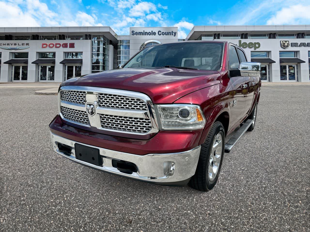 2017 RAM 1500 Laramie Crew Cab 4x4 5'7' Box in Delmonico Red Pearlcoat — front three-quarter view