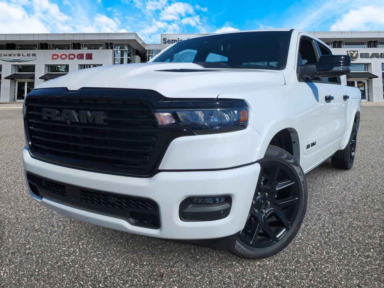2026 RAM Ram 1500 RAM 1500 LARAMIE CREW CAB 4X4 5'7' BOX in Bright White Clear-Coat Exterior Paint — front three-quarter view