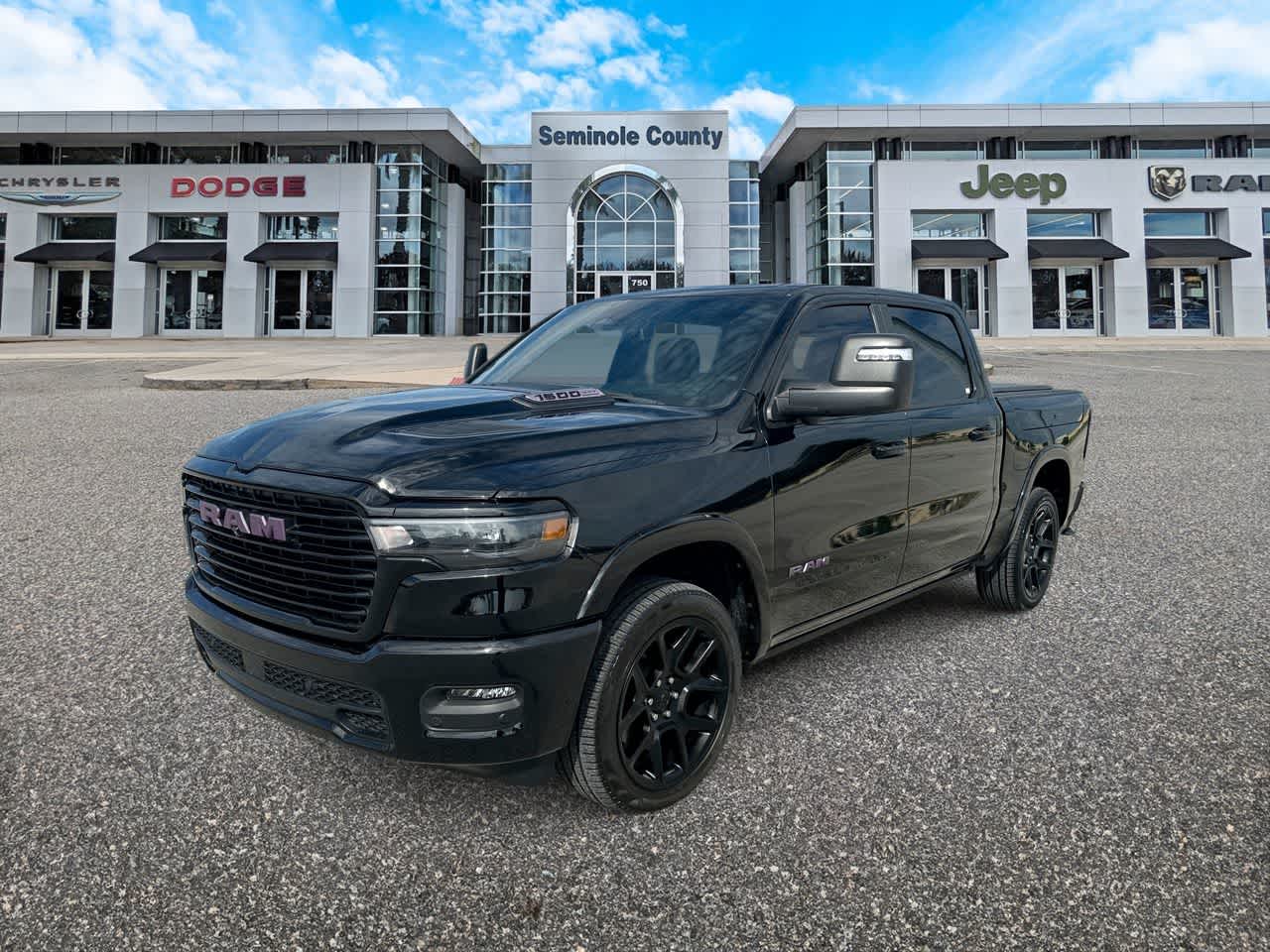 2025 RAM 1500 Laramie in Diamond Black Crystal Pearlcoat — front three-quarter view