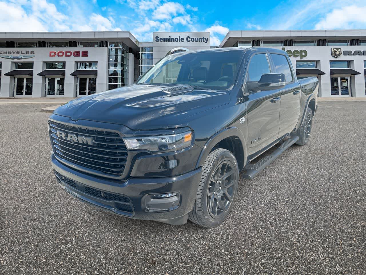 2026 RAM 1500 Laramie in Diamond Black Crystal Pearlcoat — front three-quarter view