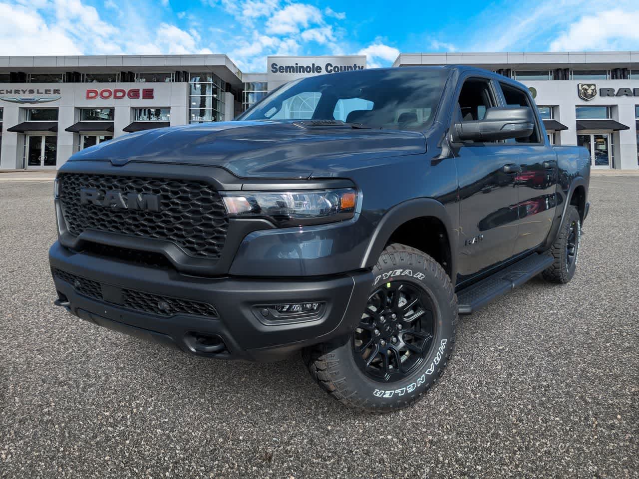 2026 RAM Ram 1500 RAM 1500 REBEL CREW CAB 4X4 5'7' BOX in Forged Blue Metallic Exterior Paint — front three-quarter view
