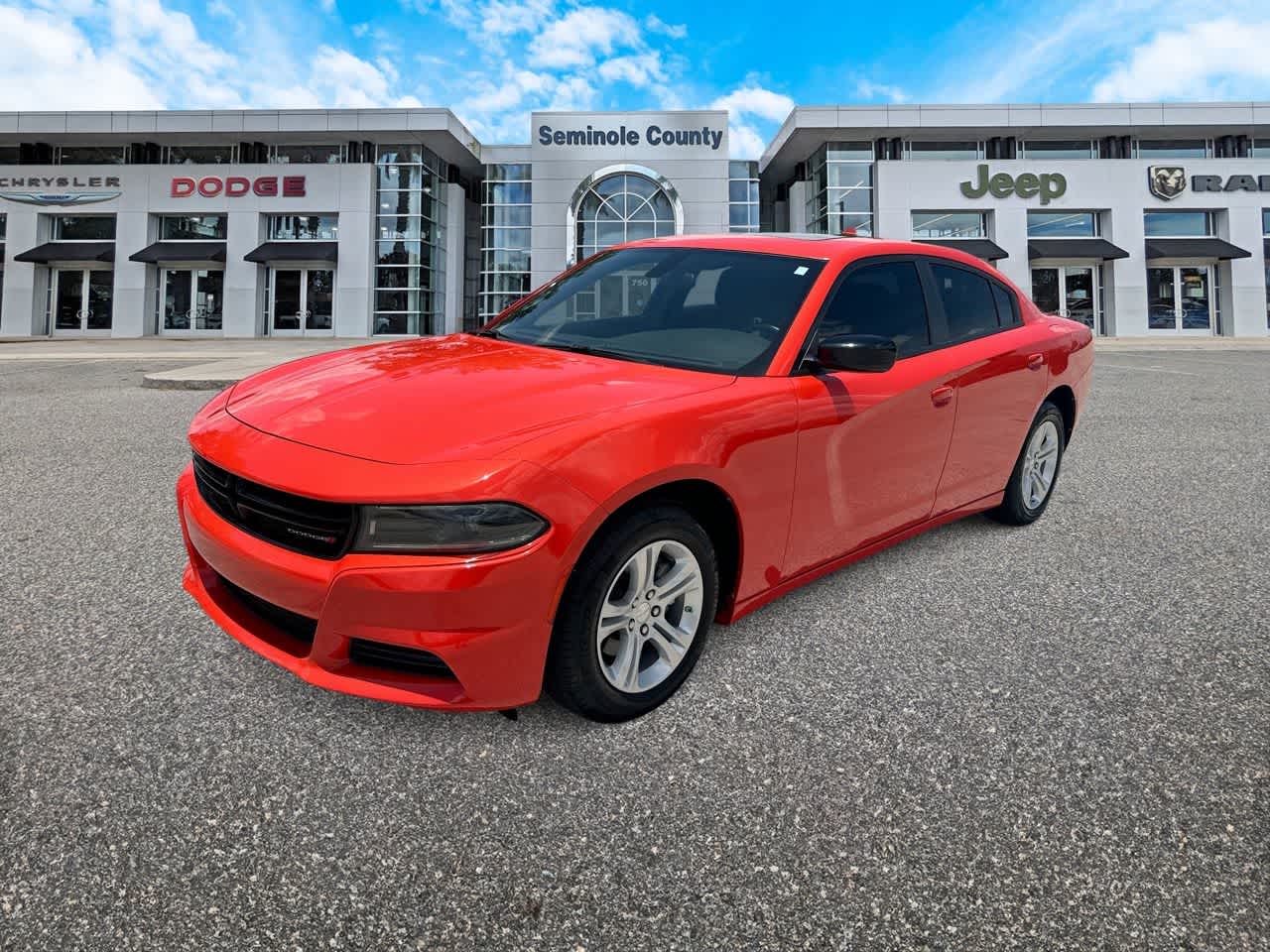 2023 Dodge Charger SXT in Go Mango — front three-quarter view