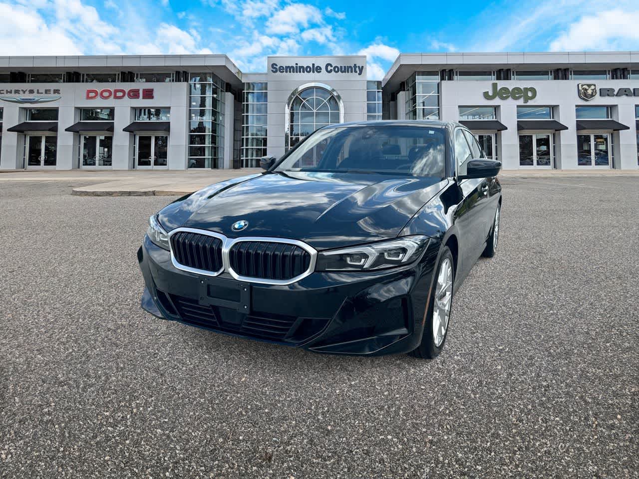 2025 BMW 330i xDrive in Black — front three-quarter view