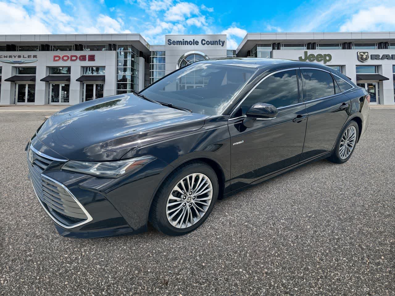 2021 Toyota Avalon Limited Hybrid in Opulent Amber — front three-quarter view